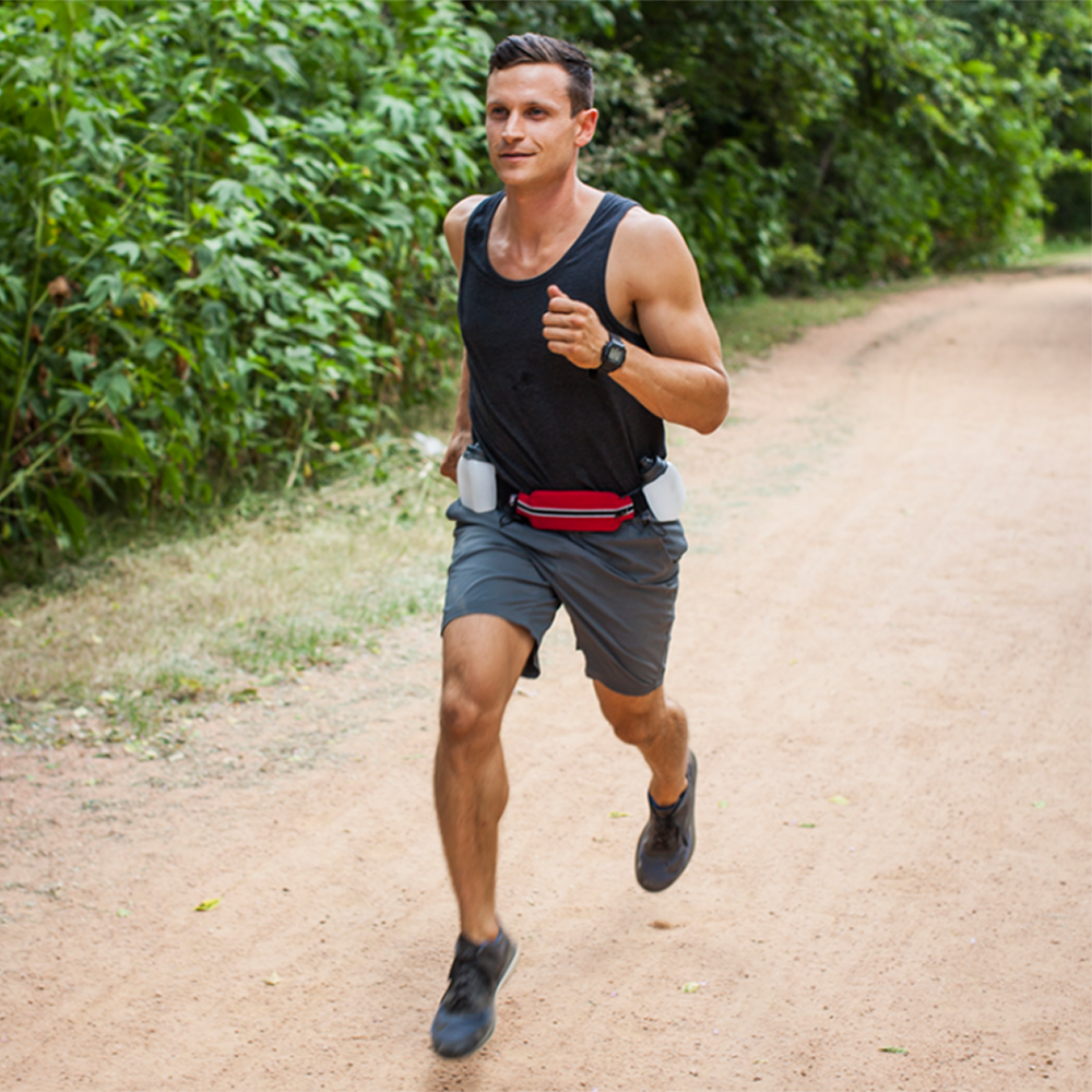 Man running on a trial with a SPIbelt-Iron Doggy H2O companion